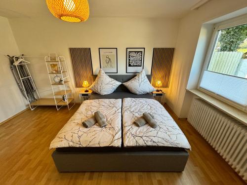 a bedroom with a bed with two pillows on it at Feel like Home 3 in Biberach an der Riß