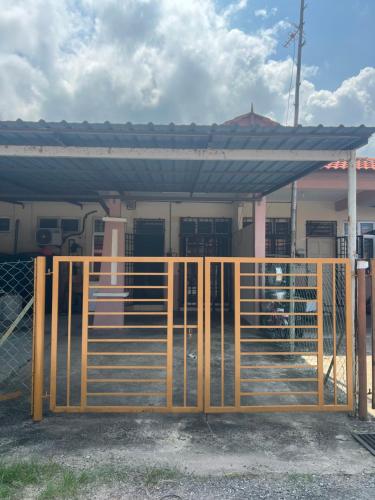 a wooden gate in front of a building at Mama Homestay in Kampong Jubakar Pantai