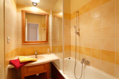 a bathroom with a tub and a sink and a shower at Appart 1 chb lit double dans jolie résidence du Lac in Monflanquin