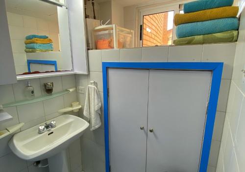 a bathroom with a white sink and a mirror at Miramar in Porlamar