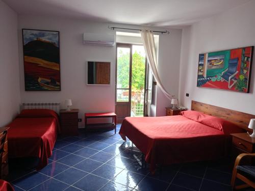a room with two beds and a window at Bed & Breakfast Maredomus in Milazzo