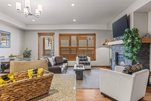 a living room with a couch and a fireplace at Spring Creek Spacious Luxury King One Bedroom plus Den at White Spruce Lodge in Canmore