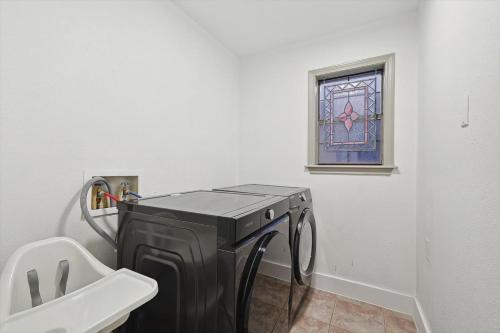 a washing machine in a bathroom with a window at Beautiful 5BR 2BA DeSoto Holiday Home with Pool in DeSoto
