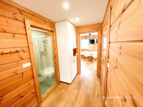 um corredor com um chuveiro e uma porta de vidro em Apartment Jeršin em Rateče