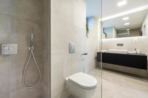 a bathroom with a shower and a toilet and a sink at SWU Opera in Budapest
