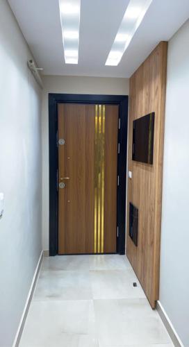 a hallway with a wooden door and a television at جامعه الدول مهندسين in Cairo