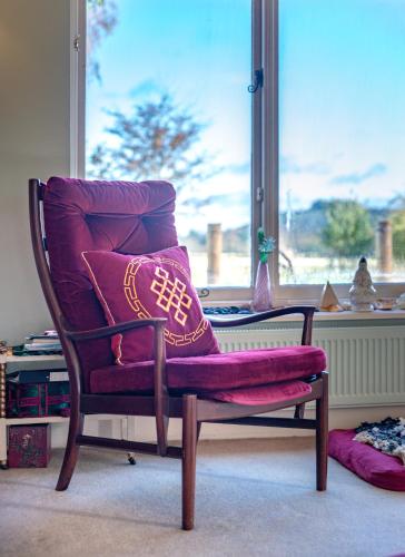 a chair with a pair of boots on it in front of a window at Luxurious, Fabulous, Fun, Contemporary Suite in Retreat Centre in Salisbury