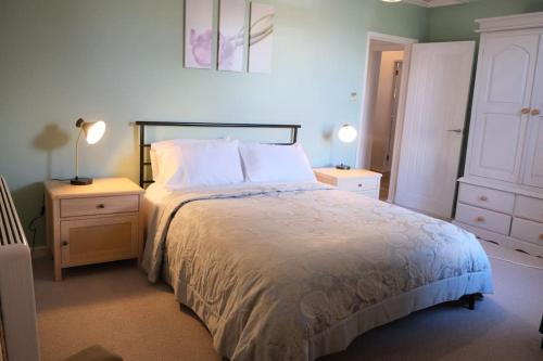 a bedroom with a large bed and two night stands at Avon's View in Stratford-upon-Avon