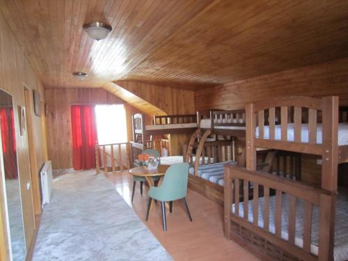 a room with four bunk beds and a table and chairs at Villa in Tbilisi in Tbilisi City