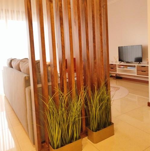 a living room with two potted plants next to a couch at RR Residence in Viana do Castelo