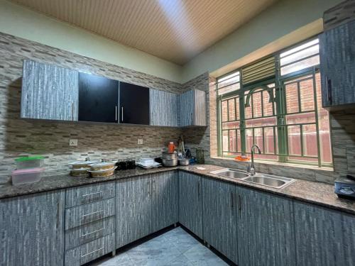 uma cozinha com um lavatório e uma bancada em MyPlace Suites 2-Bed Apartment Kagarama Kigali em Kigali