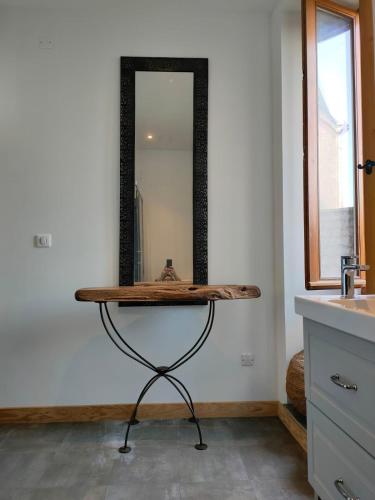 La salle de bains est pourvue d'un comptoir en bois et d'un miroir. dans l'établissement Kaya Rentals, à Belvès