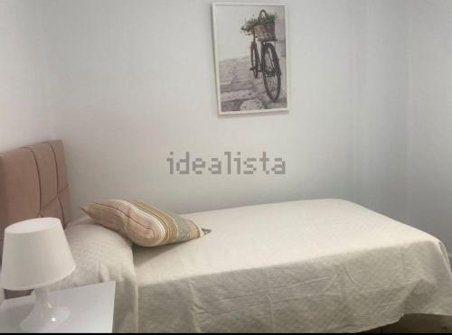 a bedroom with a bed with a bike on the wall at Castel Málaga Home in Málaga