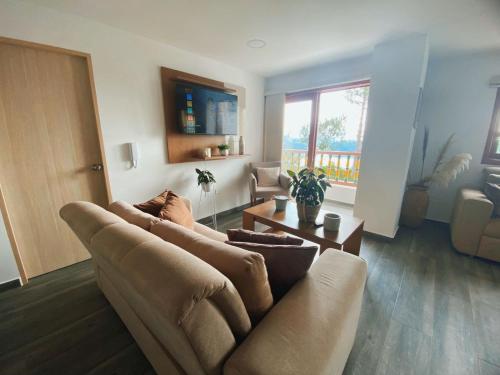 a living room with a couch and a table at Loma Rent Home Guatape in Guatapé