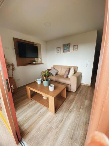 a living room with a couch and a coffee table at Loma Rent Home Guatape in Guatapé