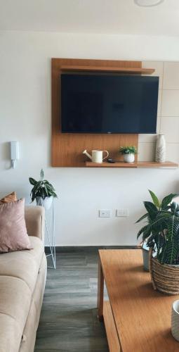 a living room with a couch and a table at Loma Rent Home Guatape in Guatapé