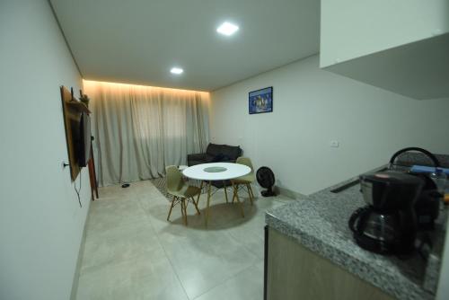 a kitchen with a table and a small table and chairs at Apart Hotel Neri in Sinop