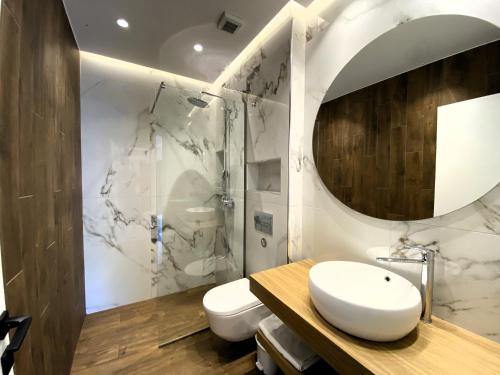 a bathroom with a sink and a mirror at Platinum River Apartments in Potamós