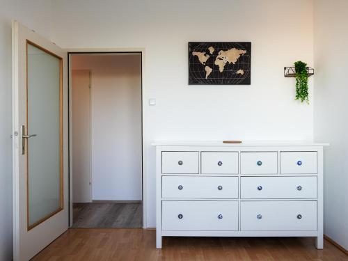 a bedroom with a white dresser and a mirror at Spacious Apartments with View & Free Parking in Wiener Neustadt