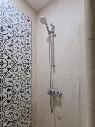a shower stall in a bathroom with a shower head at Maison d'hôte Bousaid in Chefchaouene