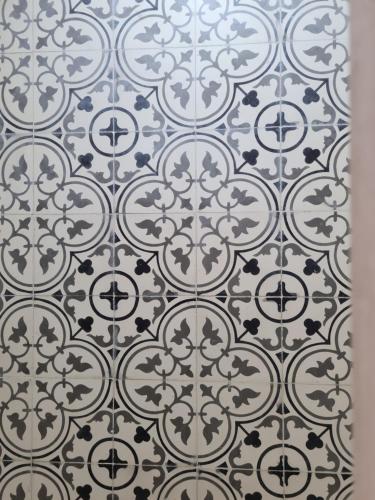 a white tile floor with a pattern on it at Maison d'hôte Bousaid in Chefchaouene