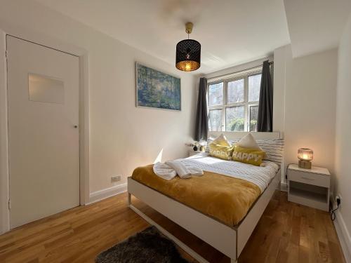 a bedroom with a bed and a window at Marble Arch 3-Bedroom Family Flat in Central London in London