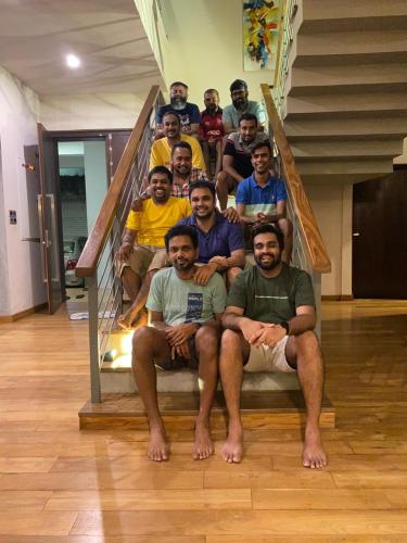 a group of people sitting on a staircase at Thalangama Lakeview Lodge in Battaramulla