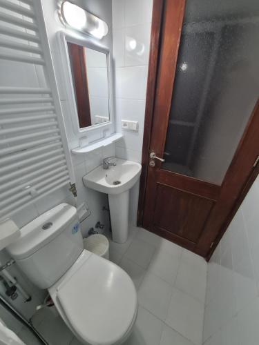 a bathroom with a toilet and a sink and a mirror at Maison d'hôte Bousaid in Chefchaouene