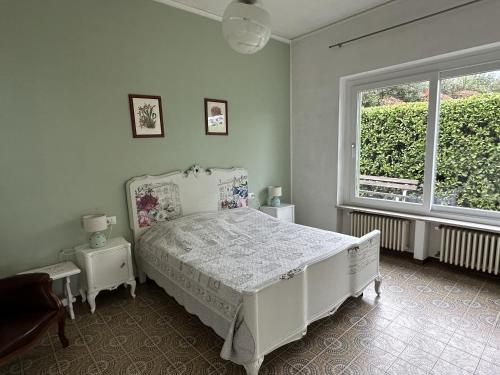 a bedroom with a white bed and a window at Villa Anastasye in Predore
