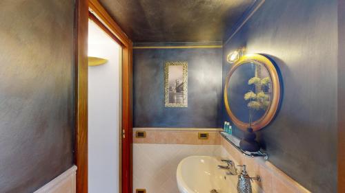 a bathroom with a sink and a mirror at Villa Platani con piscina-BGL in Manerba del Garda