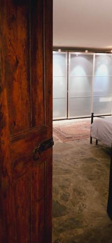 an open wooden door in a room with a bed at Historical House Medieval Abbey - Al Chiostro in Sotto il Monte
