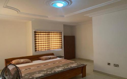 a bedroom with a large bed and a window at Rose Villa in Spintex