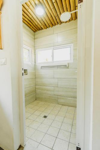 a bathroom with a shower with a tiled floor at Ocean Paradise in Barra de Santiago