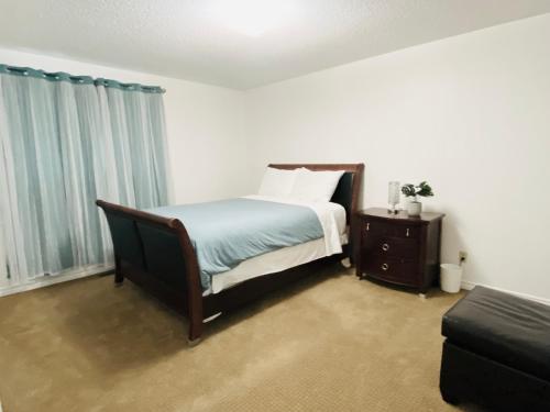 a bedroom with a bed and a table and a couch at Lovely 3 bedrooms 2 bathrooms fourplex near Calgary Downtown in Calgary