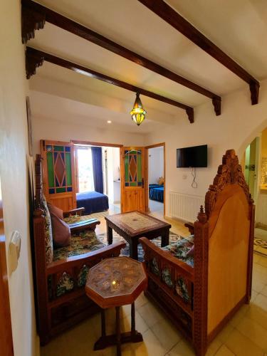 a living room with a couch and a table at Maison d'hôte Bousaid in Chefchaouene
