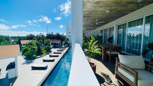 a balcony with a swimming pool on a building at Cozy Terrace @ Blue House in Puerto Aventuras