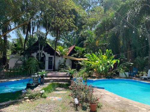 a house with a swimming pool in front of it at Hotel Mandacarú Puerto Viejo in Puerto Viejo