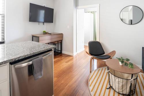 a kitchen with a counter and a table with a chair at OTR, QUEEN Bed, 50in TV, Workspace, Near Lightrail in Cincinnati