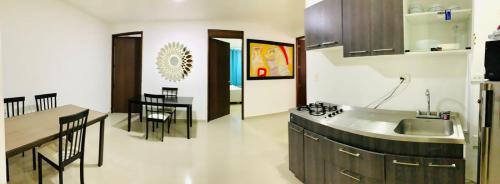 a kitchen with a sink and a counter top at Apartahotel Bahia Tropical II in San Andrés