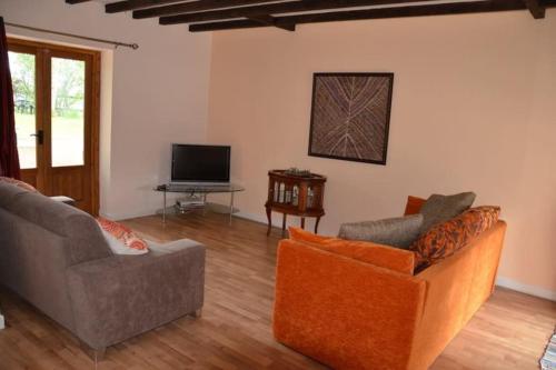 a living room with two couches and a television at Magnificent 18th Century, 5 Star Luxury Spa in Melleray-la-Vallée