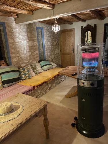 a room with a bed and a bird cage at Dar Volubilis spacieuse villa avec piscine, 5 chambres vue sur forêt in Essaouira