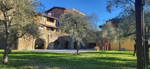 a large stone building with trees in the foreground at Appartamento Virginia in Monti di Licciana Nardi