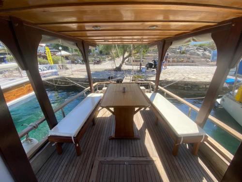 un barco con dos bancos y una mesa en la cubierta en OluGide Tekne Turu, en Datça