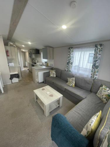 a living room with a couch and a table at Loch View 30 in Stranraer