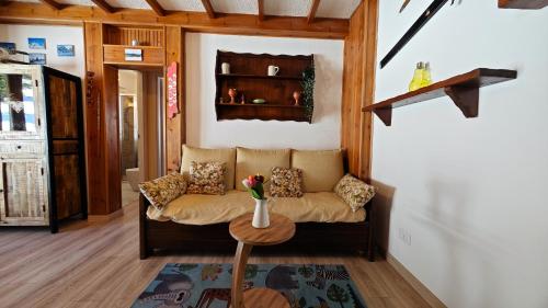 a living room with a couch and a table at Hostdomus - Seguret in Cesana Torinese