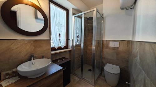 a bathroom with a sink and a shower and a toilet at Hostdomus - Seguret in Cesana Torinese