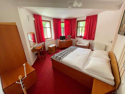1 dormitorio con 1 cama y escritorio con TV en Motel na vrchu Baba s.r.o., en Pezinok