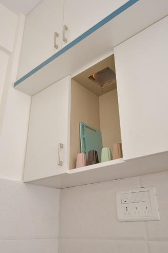 a shelf in a bathroom with a mirror at HomeSlice Whitefield in Bengaluru
