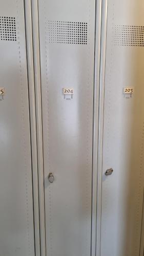 a row of white lockers with numbers on them at Appartement AX - proche départ rando - piscine - balcon - Le blancflocon in Ax-les-Thermes