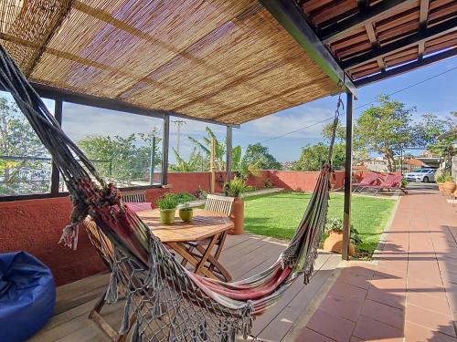 a hammock on the patio of a house at Alojamento Funchal - Silvestre House in Funchal